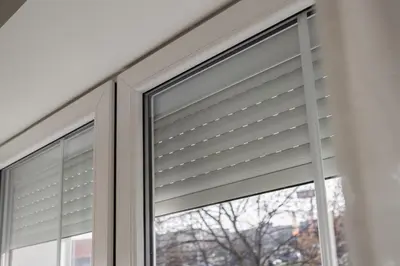 a window with a roller blind in a house at Spacious 4-Story Home with Sauna & Garden in Prague