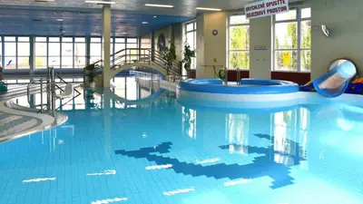 a large swimming pool with a slide in a building at Pretty private Apartment U LABE, self-service check-in 24 l 7 in Neratovice