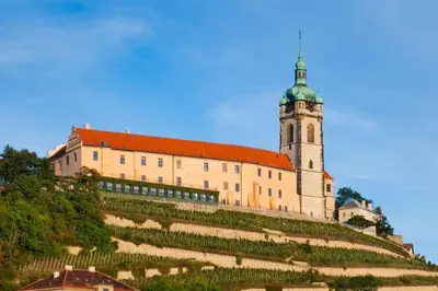 a building with a tower on top of a hill at Pretty private Apartment U LABE, self-service check-in 24 l 7 in Neratovice