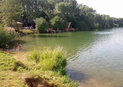 two people playing in the water at a lake at Pretty private Apartment U LABE, self-service check-in 24 l 7 in Neratovice