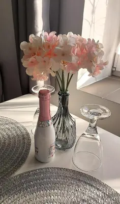 a vase with pink flowers in it on a table at Pretty private Apartment U LABE, self-service check-in 24 l 7 in Neratovice