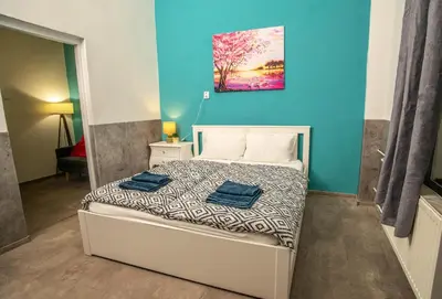 a bedroom with a bed with two towels on it at Grand apartment near Dancing House in Prague