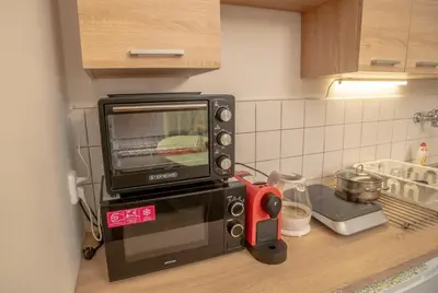 a microwave sitting on top of a kitchen counter at Grand apartment near Dancing House in Prague
