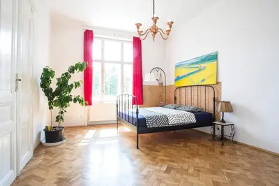 a bedroom with a bed and a potted plant at Rain Man's Apartment in Prague