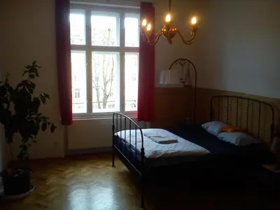 a bedroom with a bed in front of a window at Rain Man's Apartment in Prague