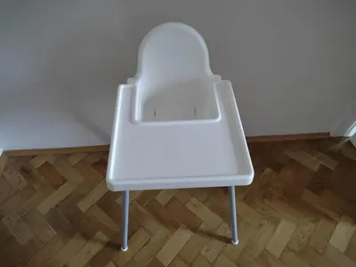 a white chair sitting on top of a wooden floor at Rain Man's Apartment in Prague