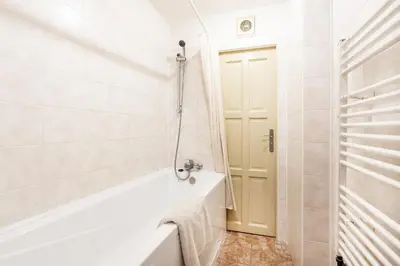 a white bathroom with a tub and a shower at Prague Days - Old Town Apartments in TOP location in Prague