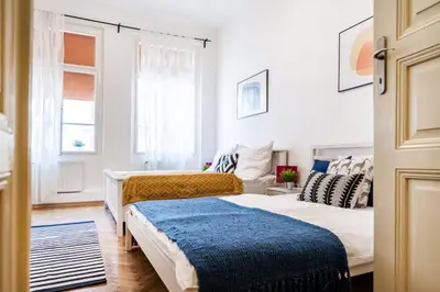a bedroom with two beds and a couch at Prague Days - Old Town Apartments in TOP location in Prague
