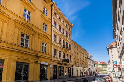 a yellow building on the side of a street at Prague Days - Old Town Apartments in TOP location in Prague