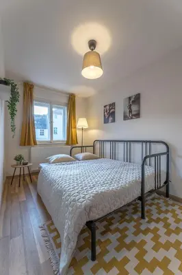a bedroom with a bed and two chairs in it at Prague Days - Old Town Apartments in TOP location in Prague