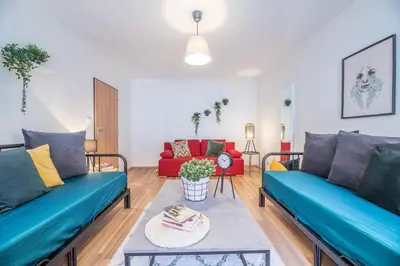a living room with two blue couches and a red couch at Prague Days - Old Town Apartments in TOP location in Prague
