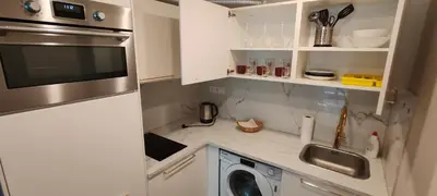 a small kitchen with a sink and a microwave at Opletal Echoes in Prague