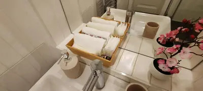 a bathroom with a toilet and a sink with towels at Opletal Echoes in Prague