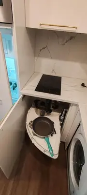a small kitchen with a toilet in a cabinet at Opletal Echoes in Prague