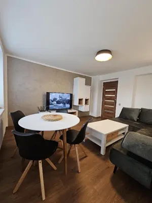a living room with a table and a couch at Apartmán U Labe in Nymburk