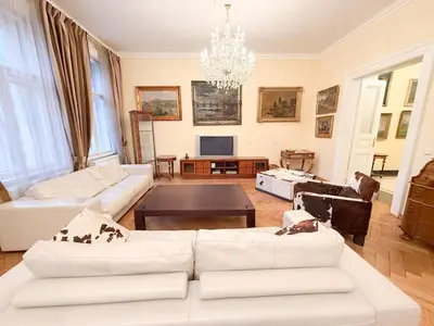 a living room with white furniture and a chandelier at Monarch Casa Residence XXL 137m2 in Prague