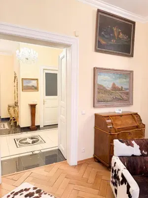 a living room with a door open to a room with a couch at Monarch Casa Residence XXL 137m2 in Prague