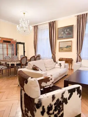 a living room with couches and a dining room at Monarch Casa Residence XXL 137m2 in Prague