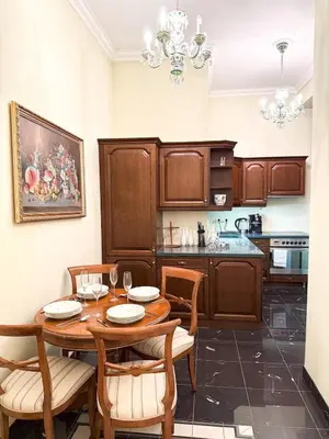 a kitchen with a wooden table and chairs at Monarch Casa Residence XXL 137m2 in Prague