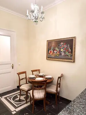a dining room with a table and chairs and a painting at Monarch Casa Residence XXL 137m2 in Prague