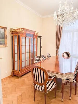 a dining room with a table and chairs and a chandelier at Monarch Casa Residence XXL 137m2 in Prague