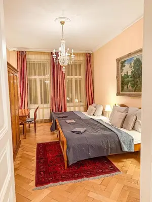 a bedroom with a bed and a chandelier at Monarch Casa Residence XXL 137m2 in Prague