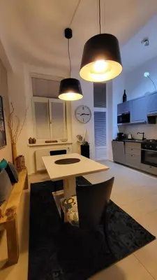 a living room with a table and two lights at Premium Apt - Center of Prague in Prague