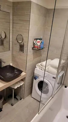 a bathroom with a washing machine and a sink at Premium Apt - Center of Prague in Prague