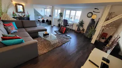 a living room with a couch and a table at Luxury Apt - View of the Center of Prague in Prague