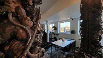 a living room with a table and a window at Luxury Apt - View of the Center of Prague in Prague
