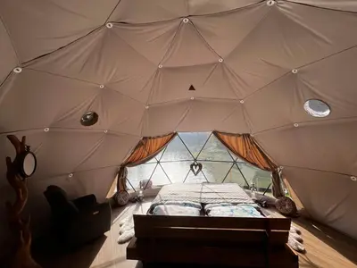 a room with a bed inside of a tent at Glamp SunnyMoon in Sudoměř