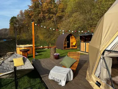 a patio with a tent and a bench and a table at Glamp SunnyMoon in Sudoměř