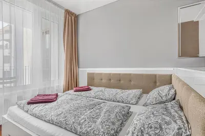 a bed with two pillows on it in a bedroom at New large apartment, Free Parking! in Prague