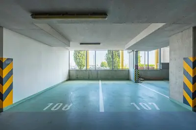 an empty parking lot in a building with a large window at New large apartment, Free Parking! in Prague