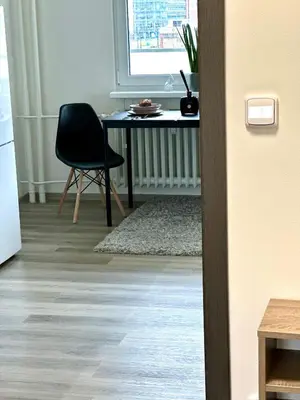 a kitchen with a table and a chair in a room at 1BDR Dazzling Apartment only 8 min to Wenceslas Square in Prague