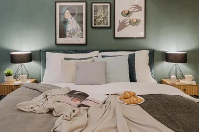 a bedroom with a bed with a plate of food on it at Prague Days - Loft-style One-bedroom Apartment in the City Center in Prague