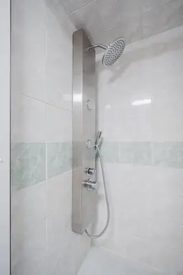 a shower with a shower head in a bathroom at Prague Days - Loft-style One-bedroom Apartment in the City Center in Prague