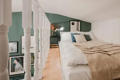 a bedroom with a white bed and a green wall at Prague Days - Loft-style One-bedroom Apartment in the City Center in Prague