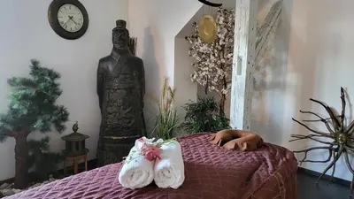 a room with a bed with a statue and a clock at Luxury Apt - Free Massages from Physiotherapists in Prague
