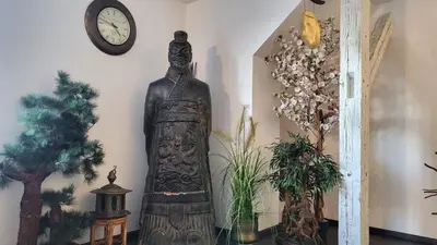 a statue in a room with a clock on the wall at Luxury Apt - Free Massages from Physiotherapists in Prague