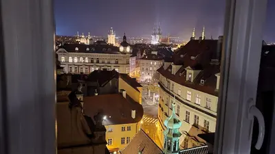 a view of a city at night from a window at Luxury Apt - Free Massages from Physiotherapists in Prague