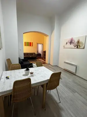 a kitchen with a wooden table and a table and chairs at Apartment Havlickova in Prague