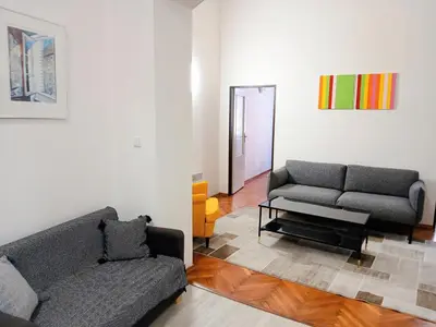 a living room with a couch and a chair at Apartment Havlickova in Prague
