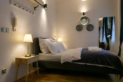 a bedroom with a bed and a table with a lamp at Cozy retreat in the Old Town in Prague