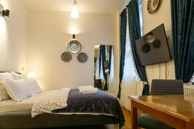 a bedroom with a bed and a desk and a table at Cozy retreat in the Old Town in Prague