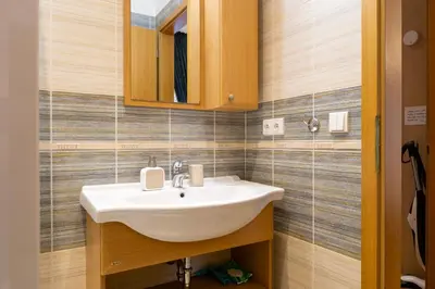 a bathroom with a sink and a mirror at Cozy retreat in the Old Town in Prague