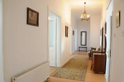 a hallway with white walls and a door with a rug at Large Apartment sleeps up to 10 M4A in Prague