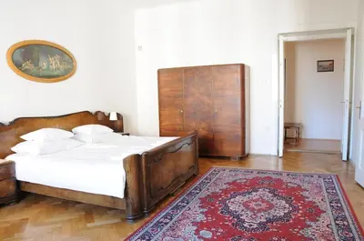 a bedroom with a large bed and a rug at Large Apartment sleeps up to 10 M4A in Prague