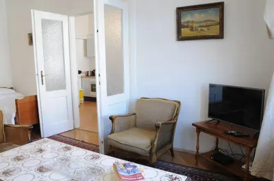 a living room with a chair and a television at Large Apartment sleeps up to 10 M4A in Prague