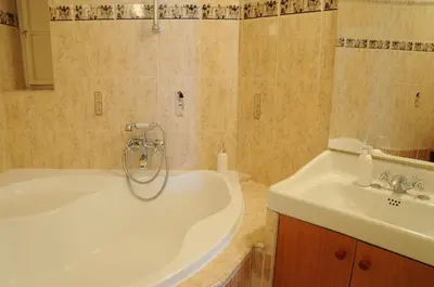 a bathroom with a tub and a sink at Large Apartment sleeps up to 10 M4A in Prague